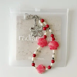 Coral Seashell phone wristlet strap in frosted packaging pouch
