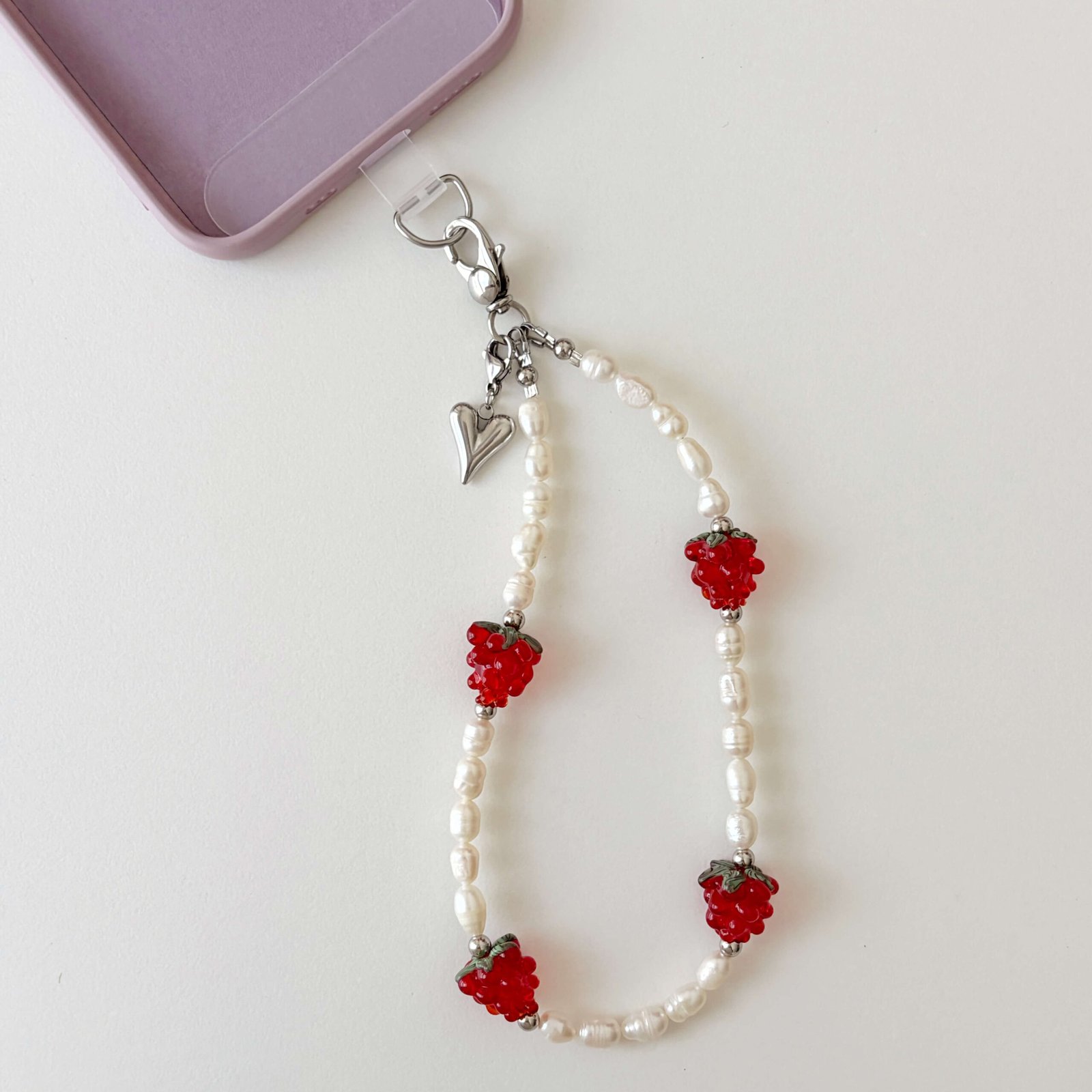 Juicy Pearl handcrafted phone wristlet strap with freshwater pearls and red glass raspberry beads