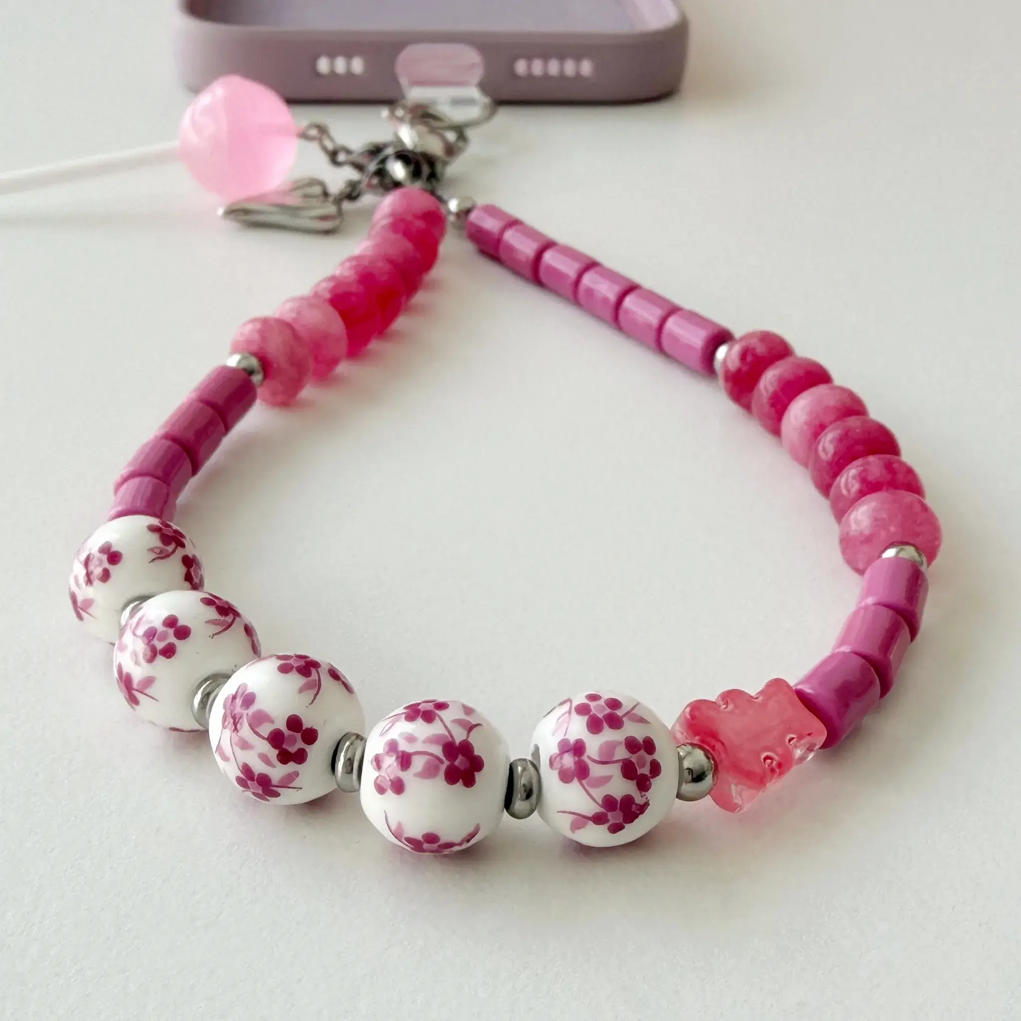 Candy Blossom beaded phone strap coiled in a circle